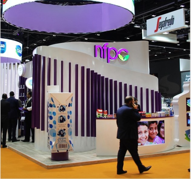 Illuminated circular brand lightboxes above the stand