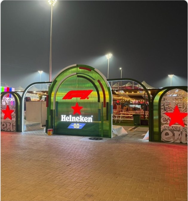 Neon-lit modular kiosk with solid-surface counter