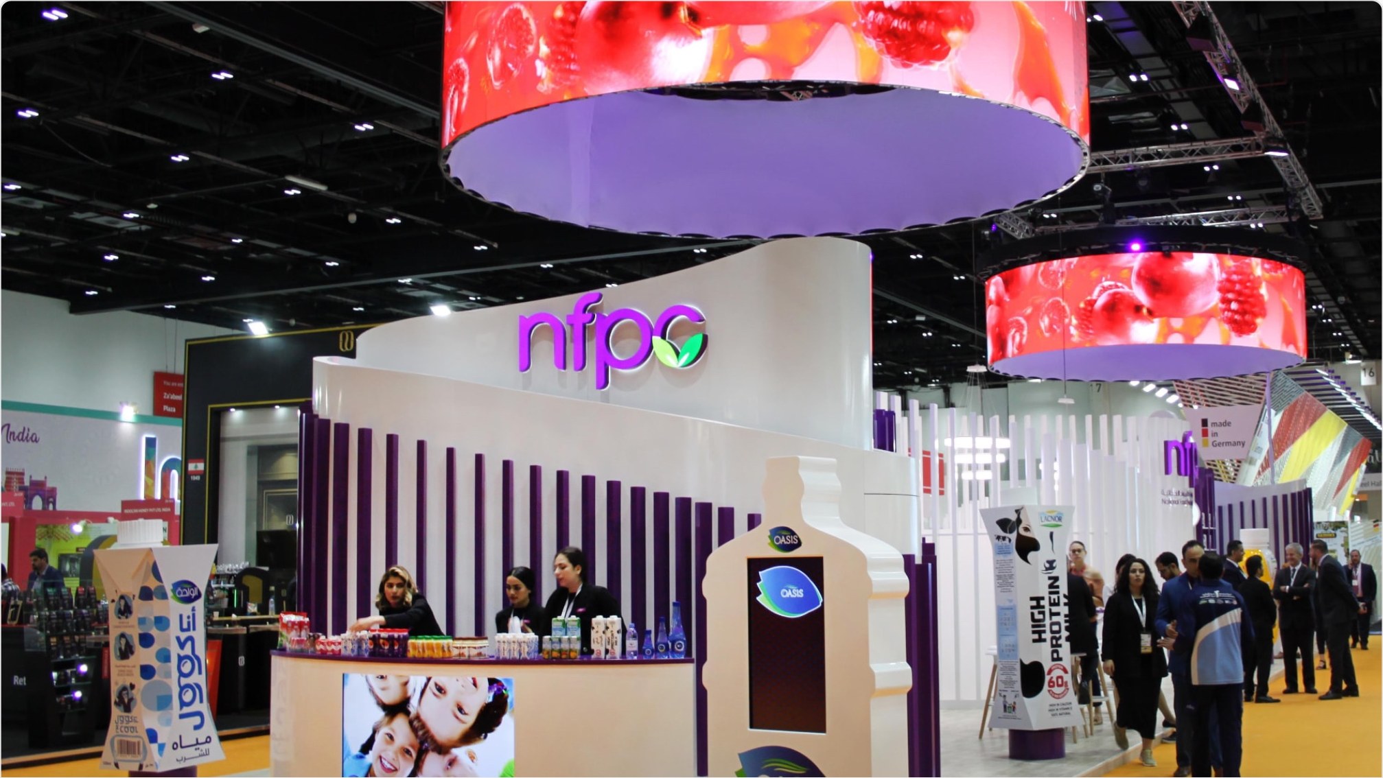 NFPC multi-brand exhibition stand with curved fin walls and LED ring gantry