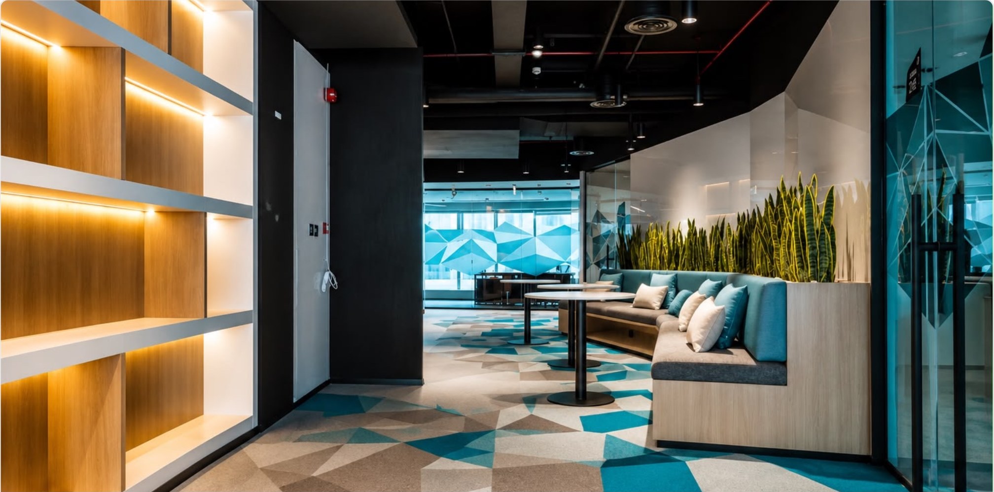 Breakout area with oak credenza units and planted screen dividers